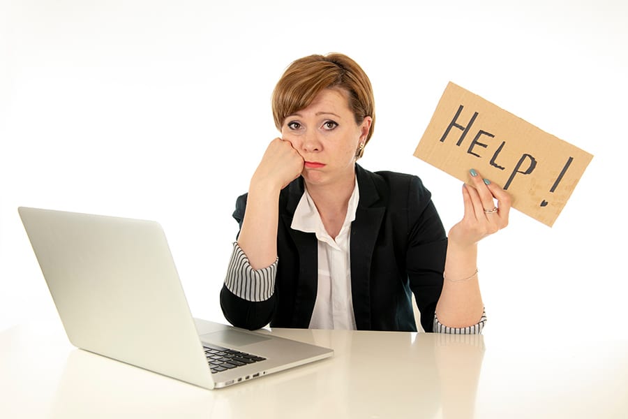 frustrated employee holding a help sign