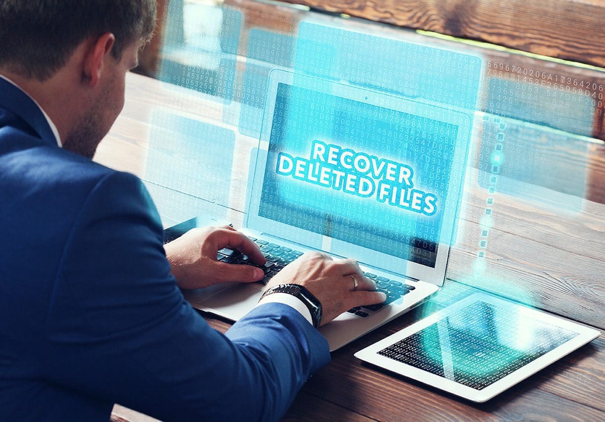 man attempting to recover deleted files from computer
