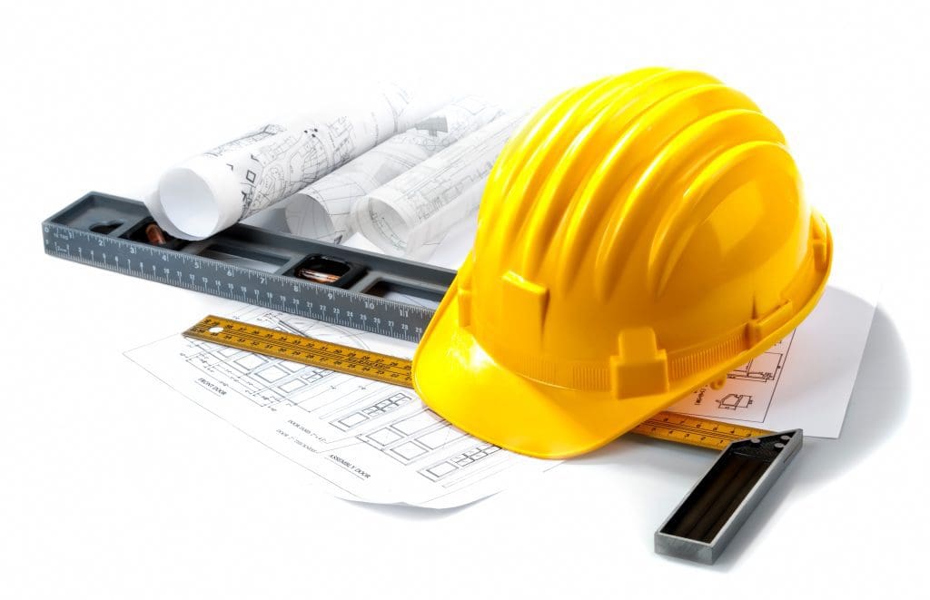 isolated hard hat with blue prints and rulers