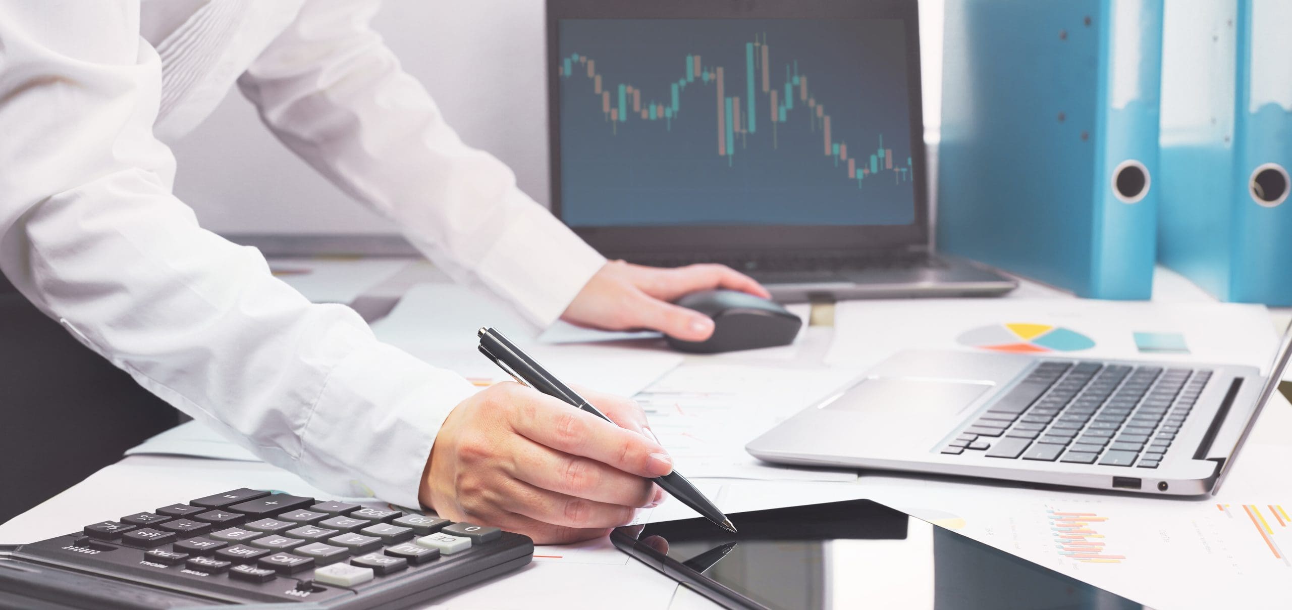 A finance expert utilizing multiple pieces of technology thanks to financial IT Support