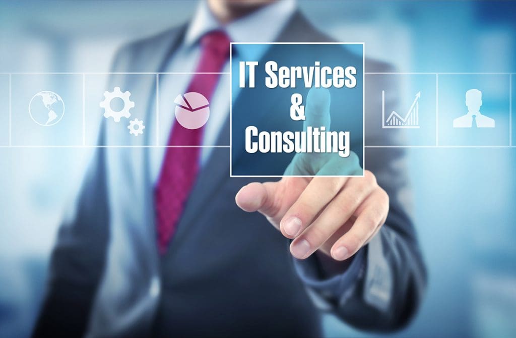 A person in a business suit touches a digital screen box that says, “IT Services & Consulting.”