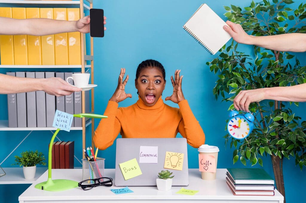 Stressed IT manager dealing with multiple technical tasks and alerts.