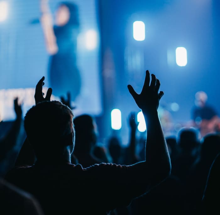 People raising hands in worship.
